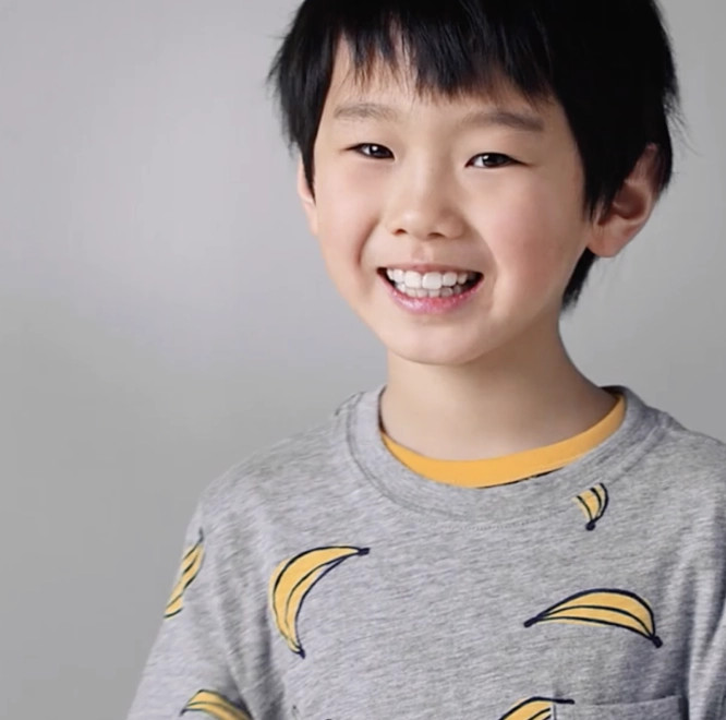 Asian little boy on gray t-shirt smiling