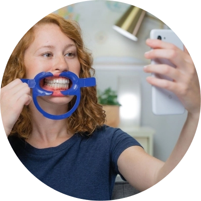 Girl taking photo of her teeth 