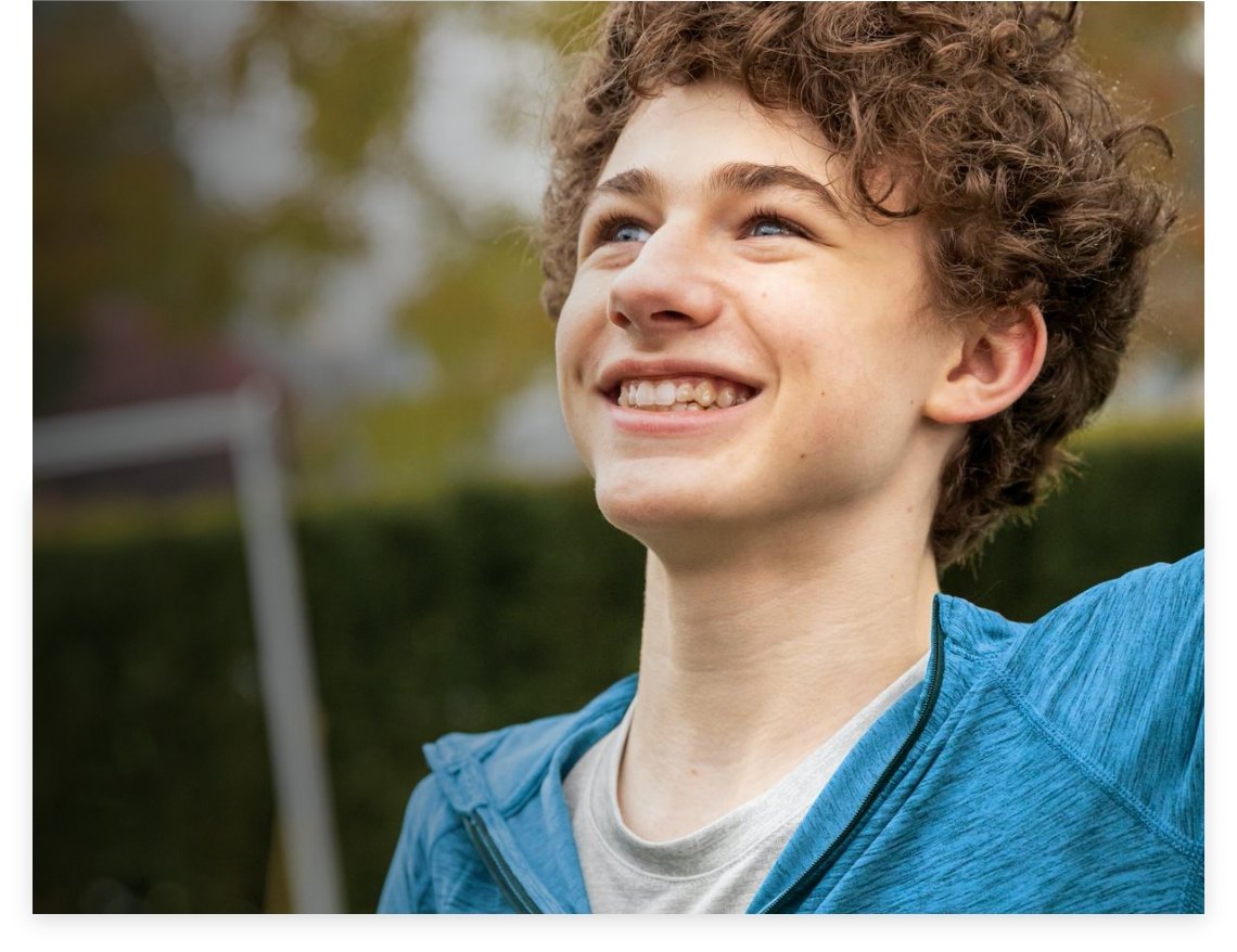 Smiling teenager wearing clear aligners