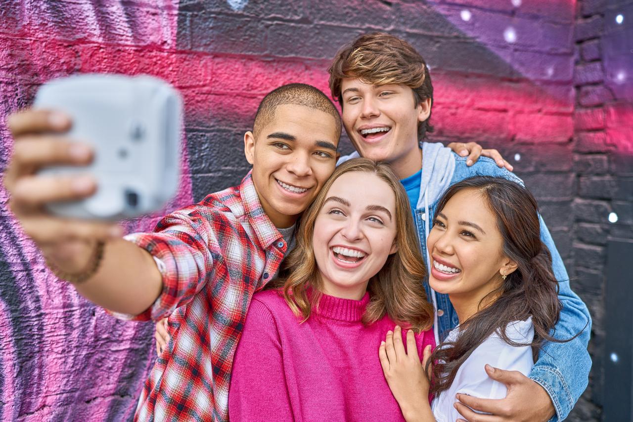 Teens smiling while taking a selfie