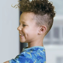 Little boy on blue t-shirt smiling