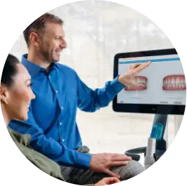 Invisalign® doctor showing his patient his new smile after using clear aligners