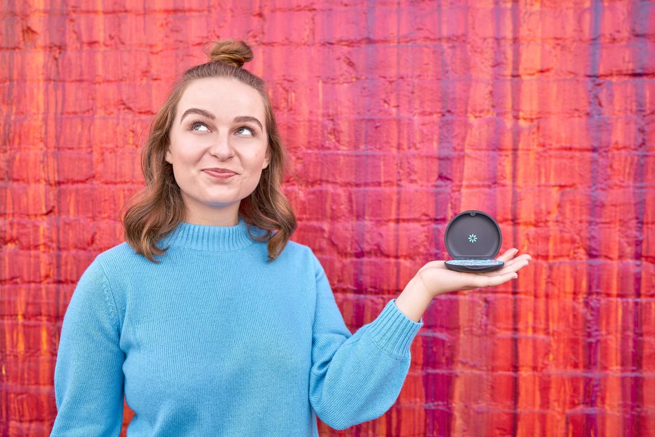 Girl holding clear aligners on her hand