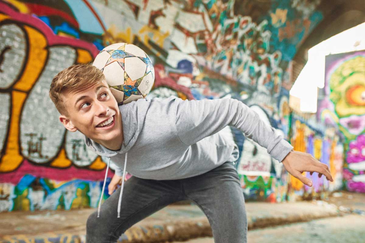 Boy playing football wearing Invisalign clear aligners