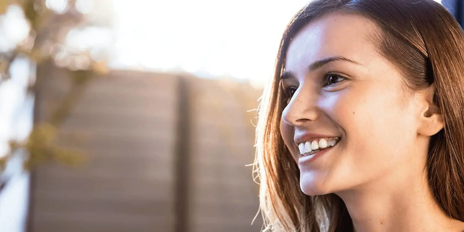 Girl smiling wearing her clear aligners Invisalign - Europe