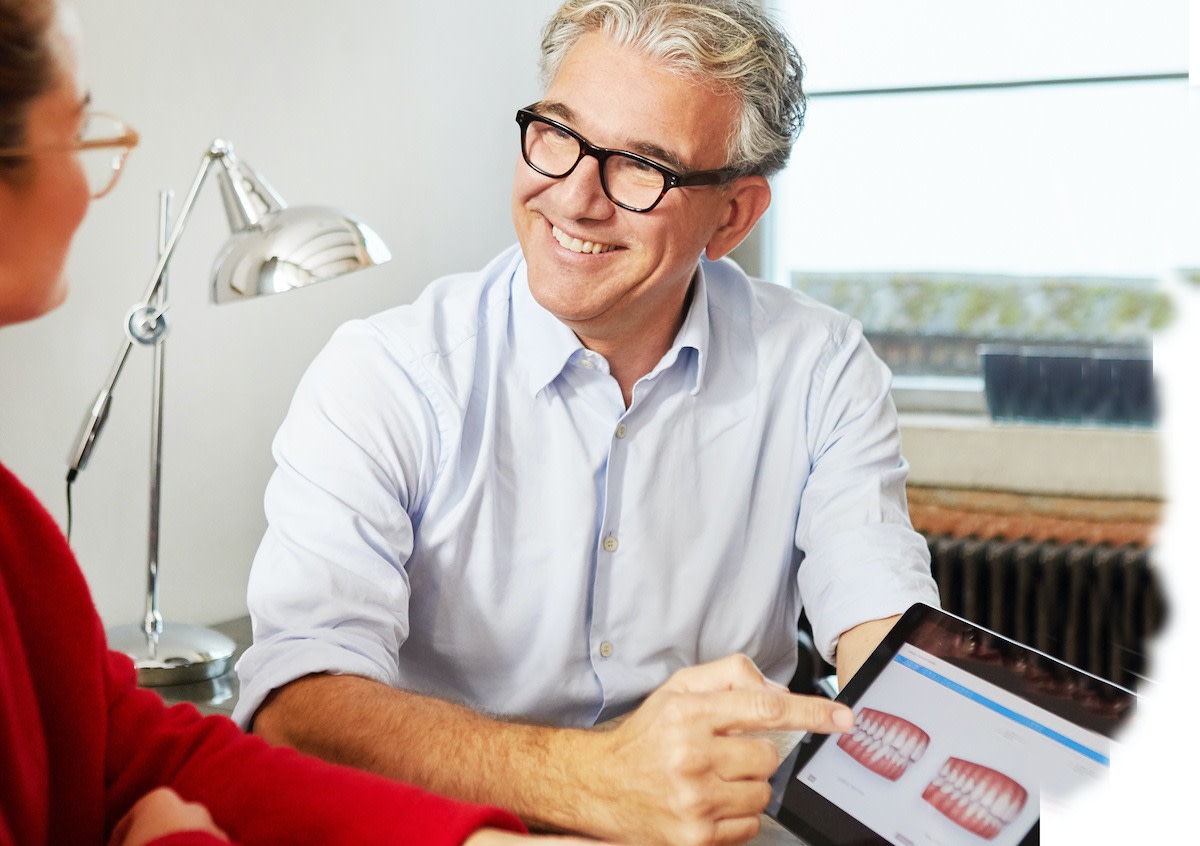 Invisalign Doctor Smiles With Patient