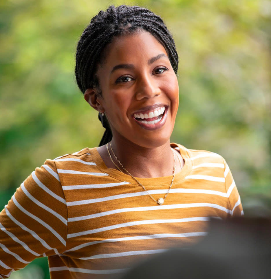 Happy woman is smiling​ after her Invisalign treatment 