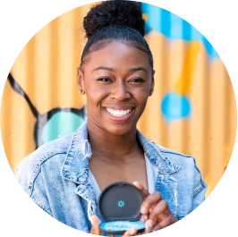 Woman holding Invisalign aligners case and smiling