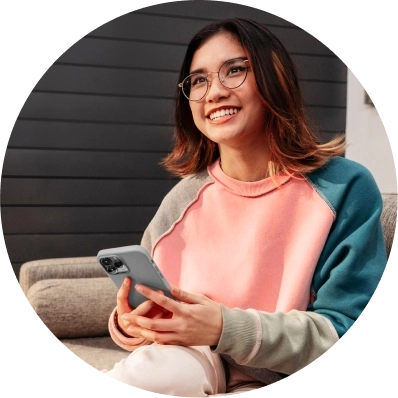 Teen smiling with her phone on her hands