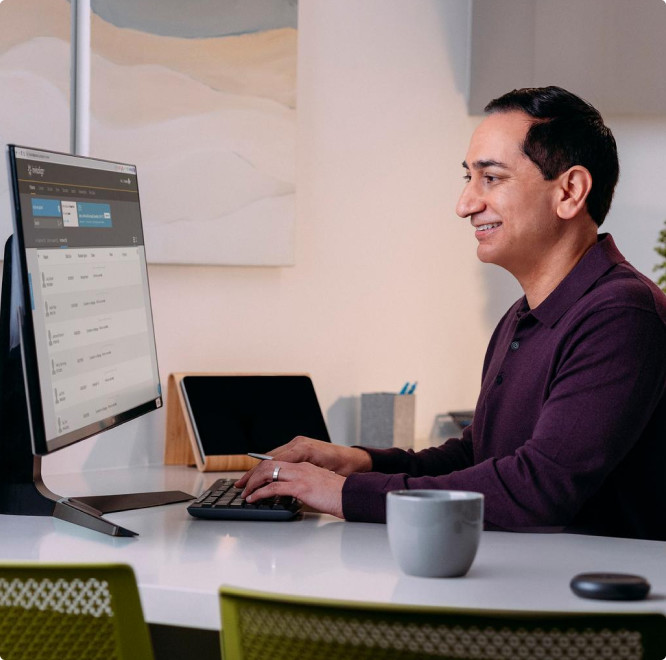 Invisalign doctor in a purple shirt using his computer