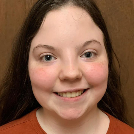 Teen girl smiling after successful Invisalign® treatment