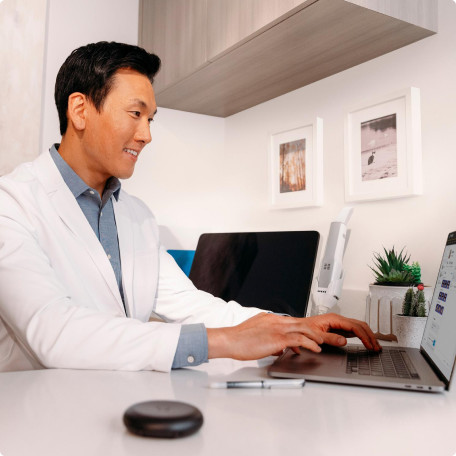 Male doctor typing on his laptop