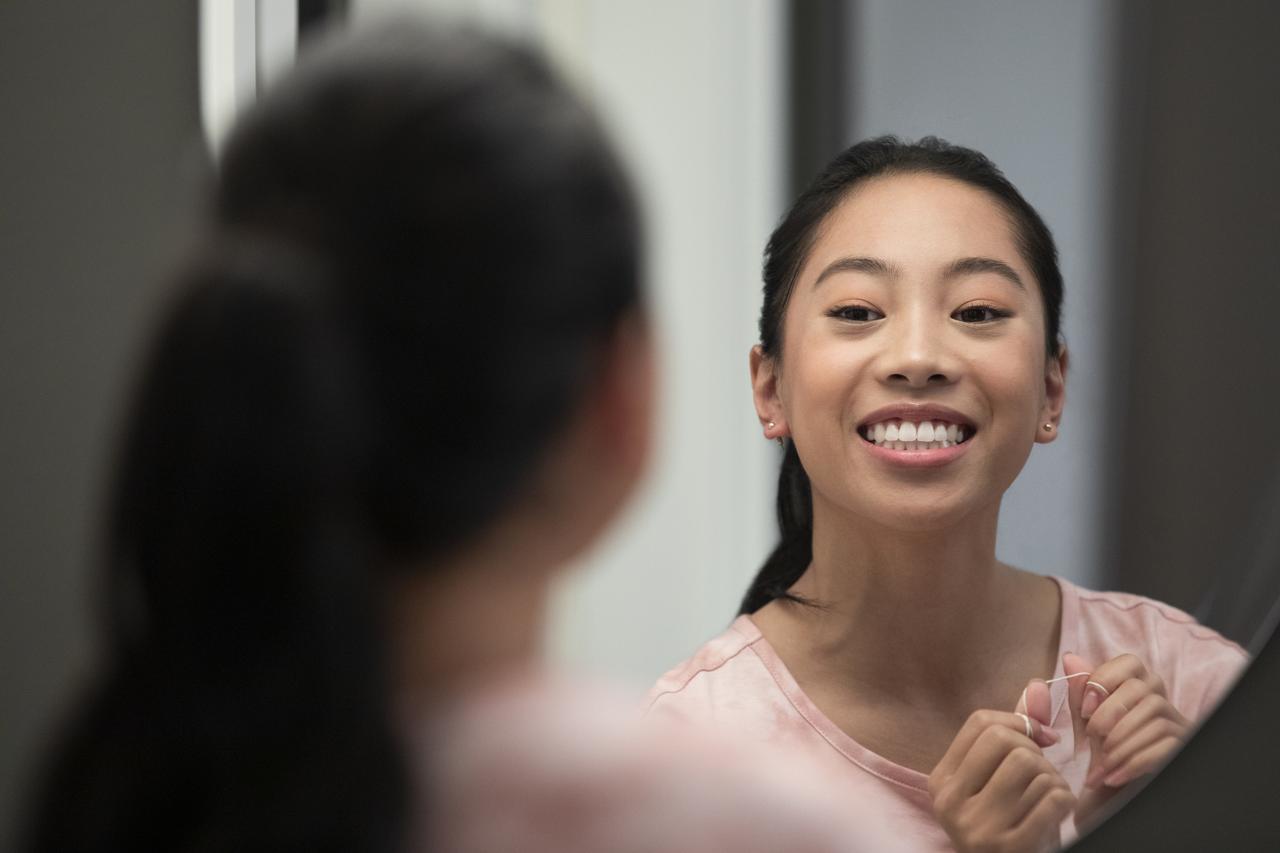 Woman smiling to the mirror