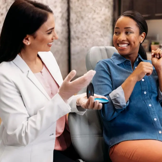 Woman discussing Invisalign® treatment with her patient