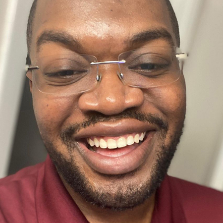 Man smiling after successful Invisalign® treatment