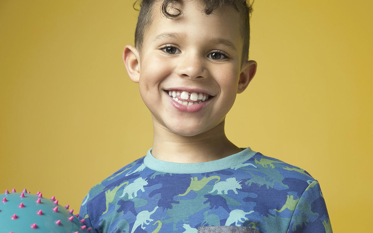 Boy with mix of baby and permanent teeth