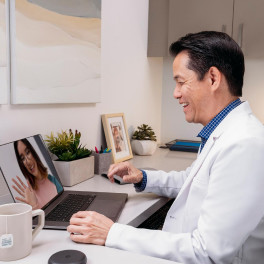 Invisalign male doctor checking teen patient's treatment progress virtually