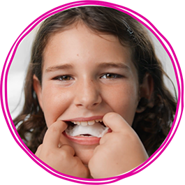 Girl putting on palatal expander