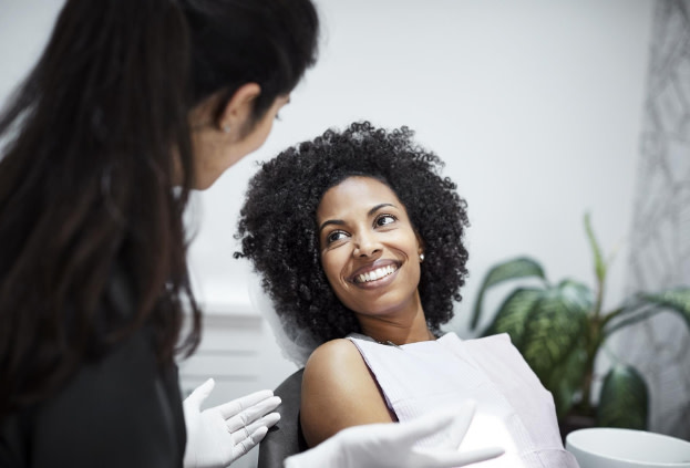 Girl smiling during an appointment with her Invisalign provider