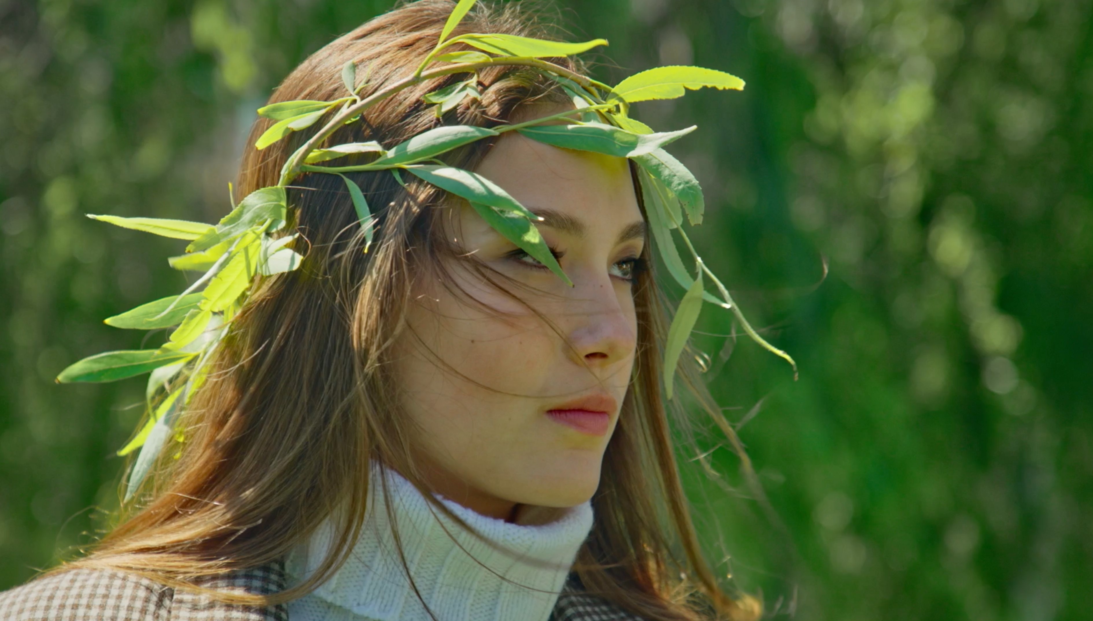 Eileen Gu wearing a green leaf crown outdoors, natural beauty portrait for X Games Aspen athlete feature