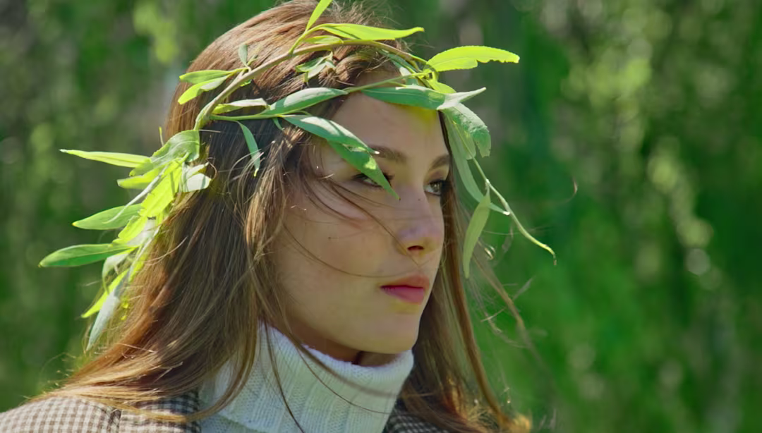 Eileen Gu wearing a green leaf crown outdoors, natural beauty portrait for X Games Aspen athlete feature