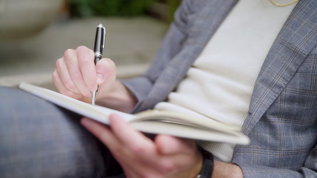 Philip Farr, San Francisco luxury real estate agent, writing notes during a client consultation. From his brand video produced by The Bureau and photographed by Drew Bird Photography.