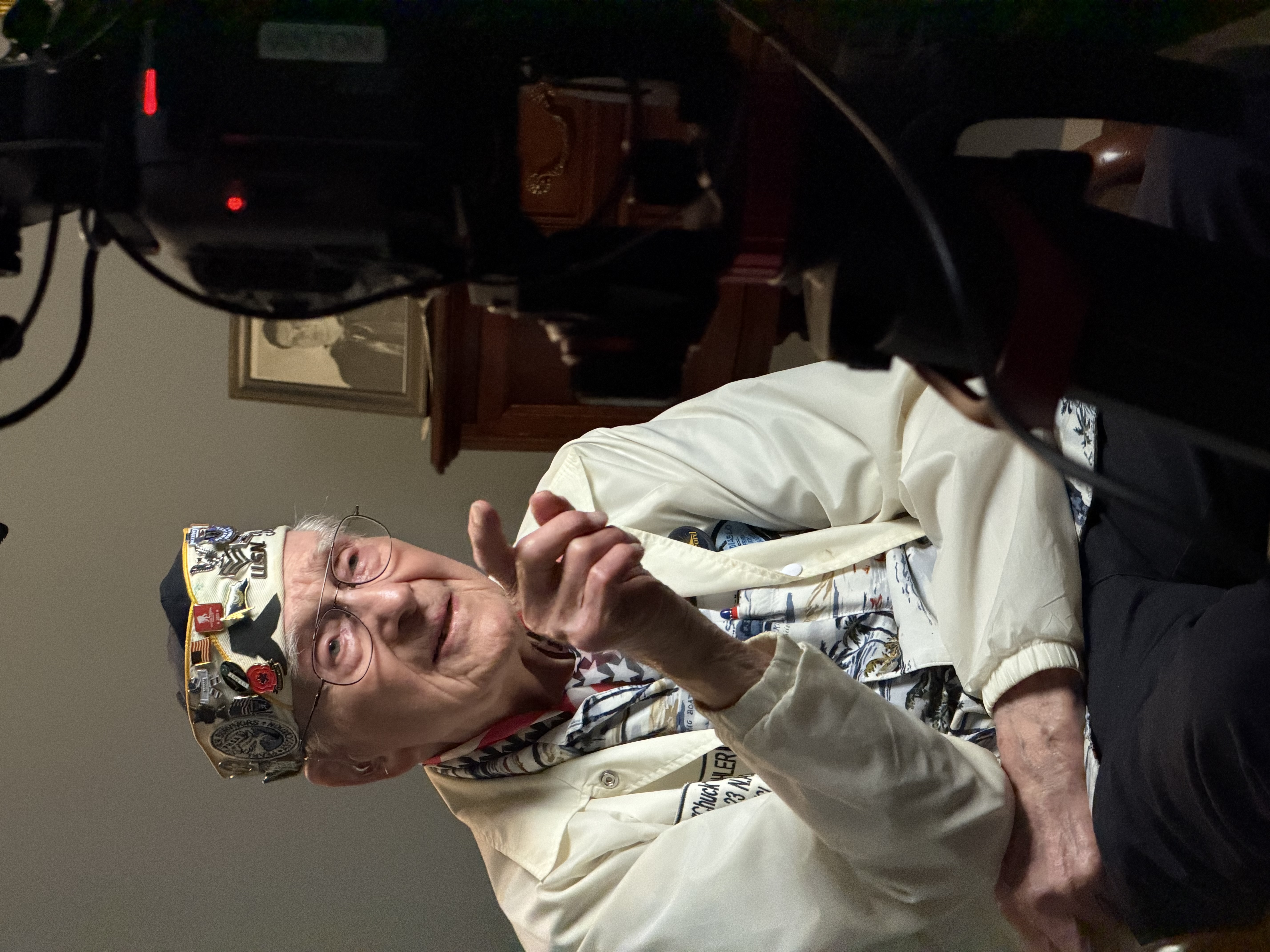 Cinematic documentary interview setup with Chuck Kohler seated under film lighting at a senior living community in the San Francisco Bay Area