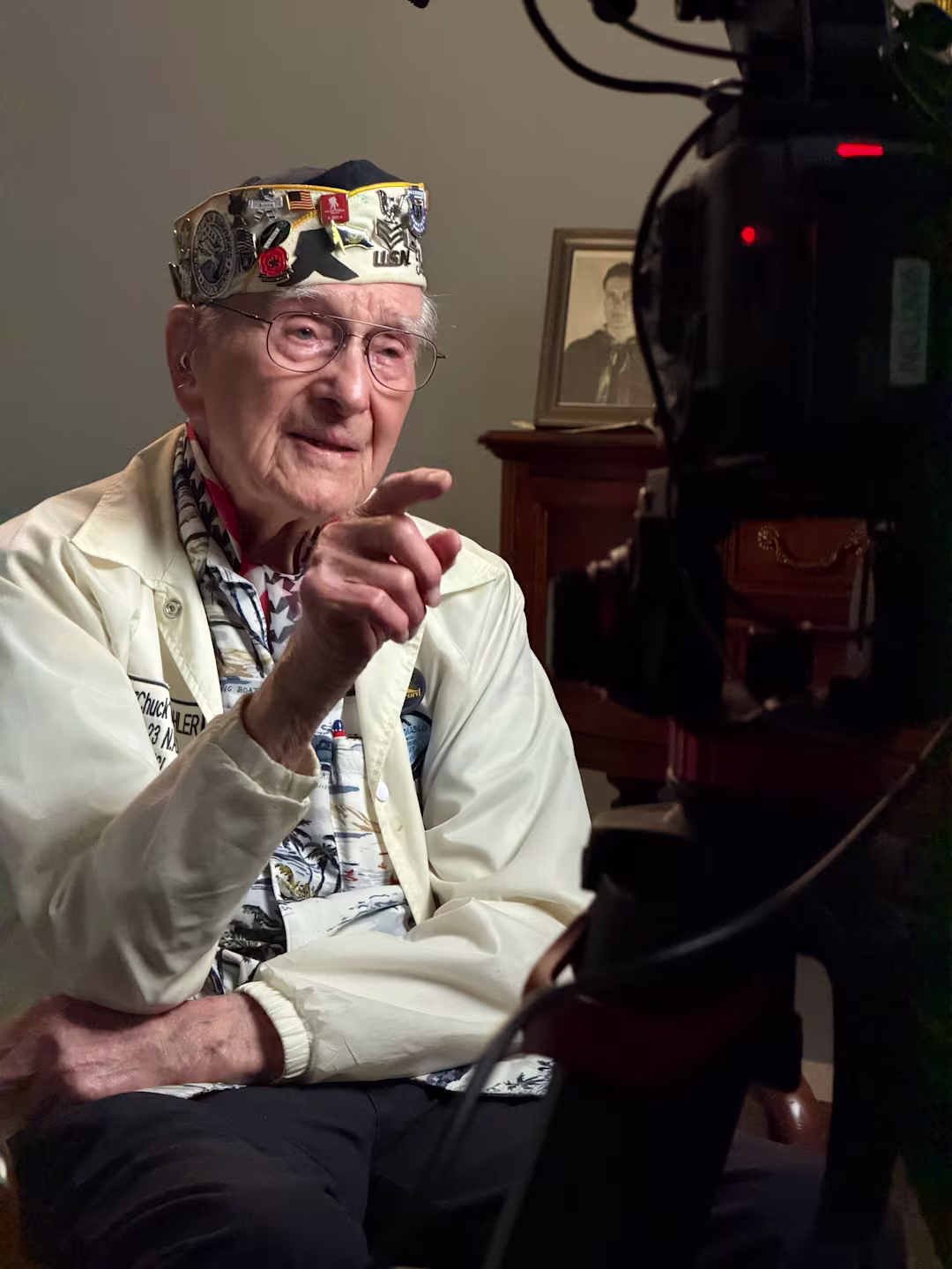 Cinematic documentary interview setup with Chuck Kohler seated under film lighting at a senior living community in the San Francisco Bay Area