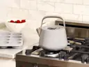 Whistling Tea Kettle - Gray - On Stove with Muffin Pan