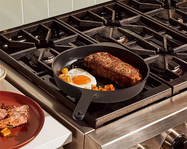 Enameled Cast Iron Skillet - Charcoal - with Food on Stovetop
