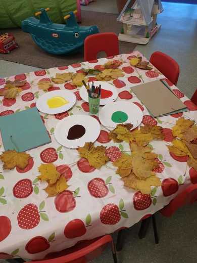 A table with paints and leaves for leaf painting