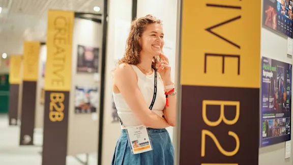 Woman with a Classic Pass smiling at The Work Gallery in the Basement of the Palais