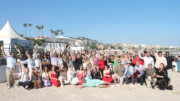 A group from the CMO Accelerator Programme gather at the beach at Cannes Lions