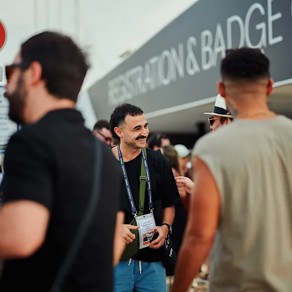 People wearing Cannes Lions delegate lanyards