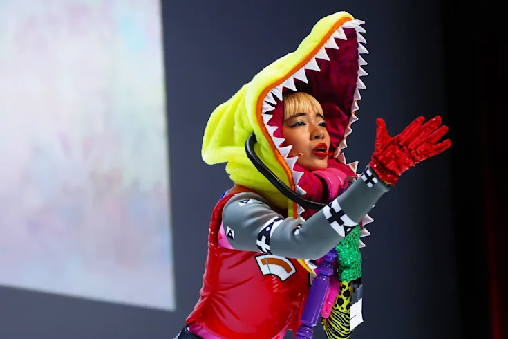 A woman is dressed with a shark's head costume at Cannes Lions.