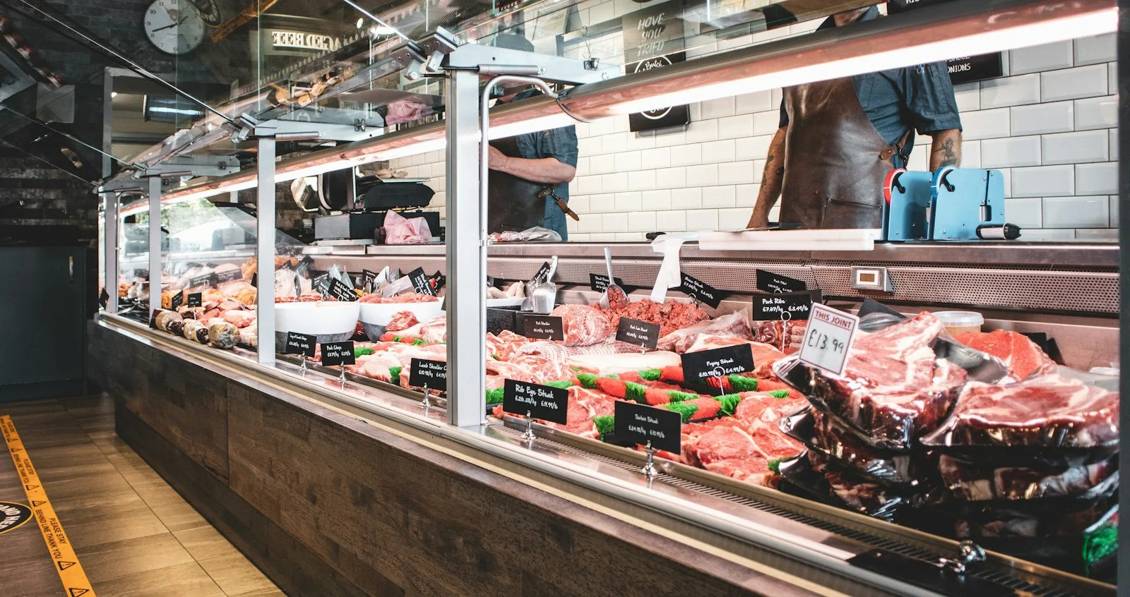 Butcher counter displaying meat cuts, illustrating the beef prices market insight