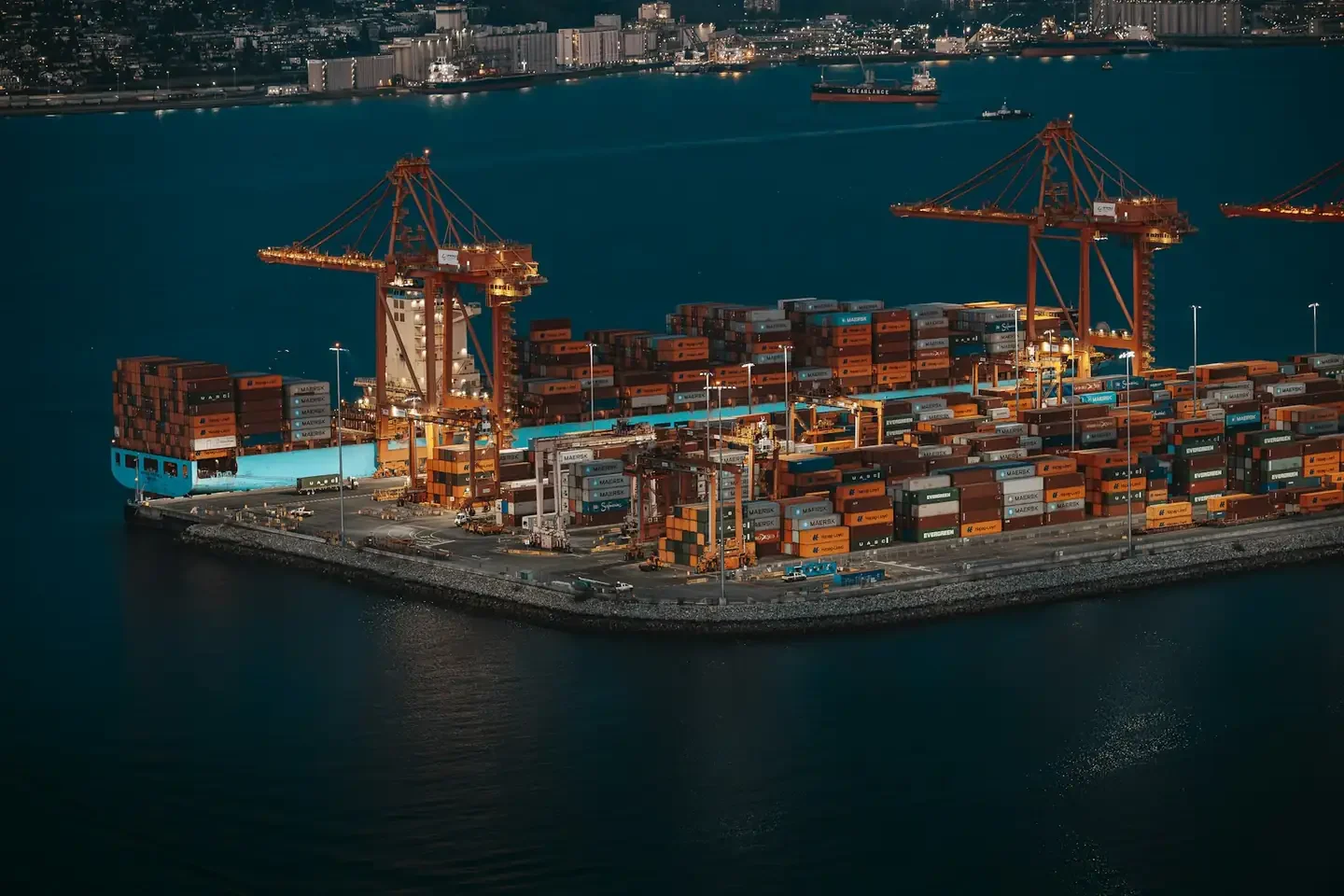 Container ship and cranes at a busy shipping port