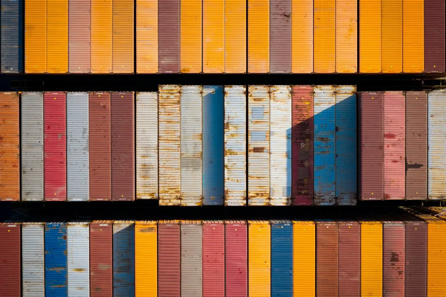 Aerial view of colorful shipping containers stacked in rows