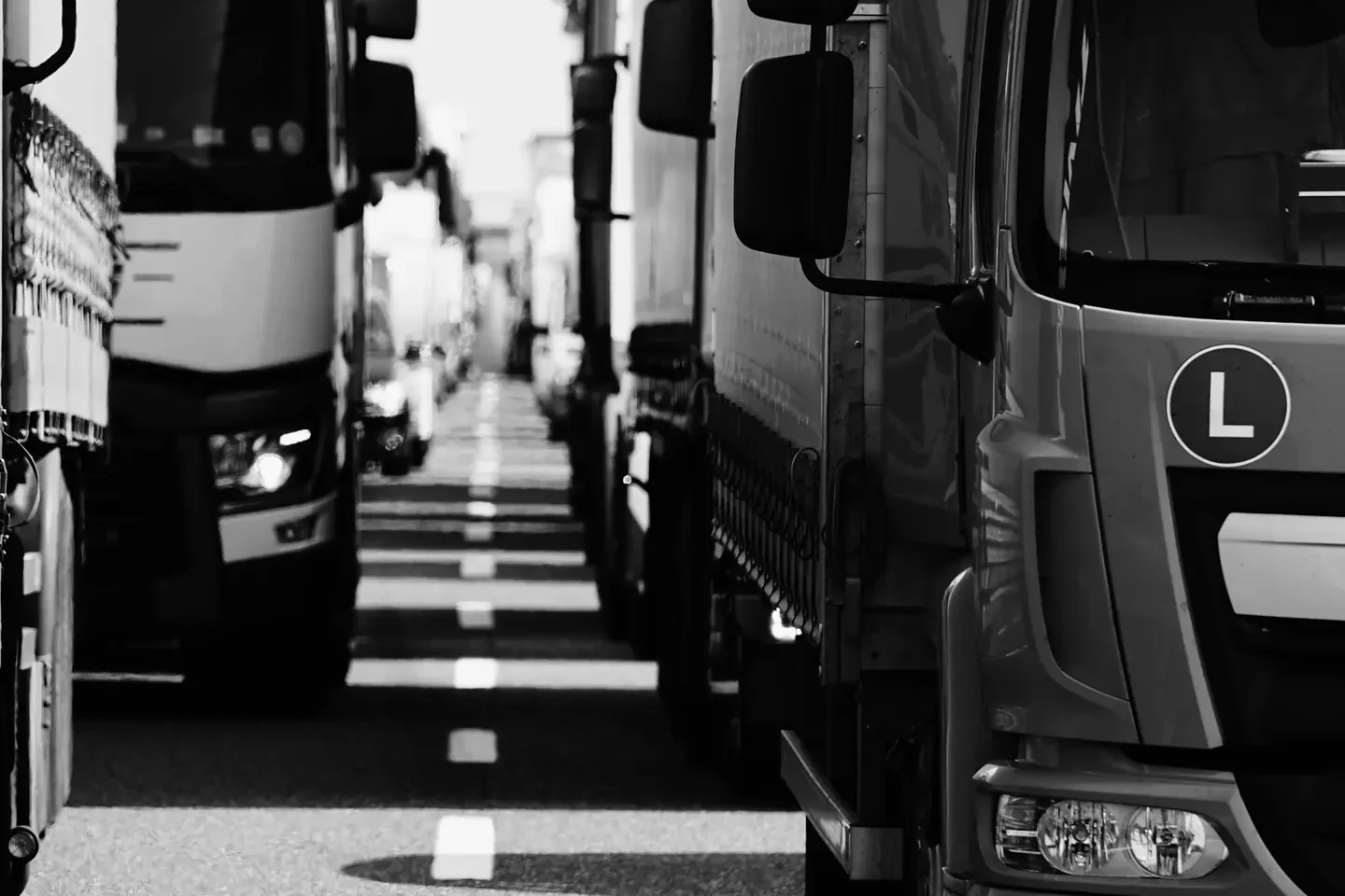 A line of semi trucks in a traffic jam on a highway