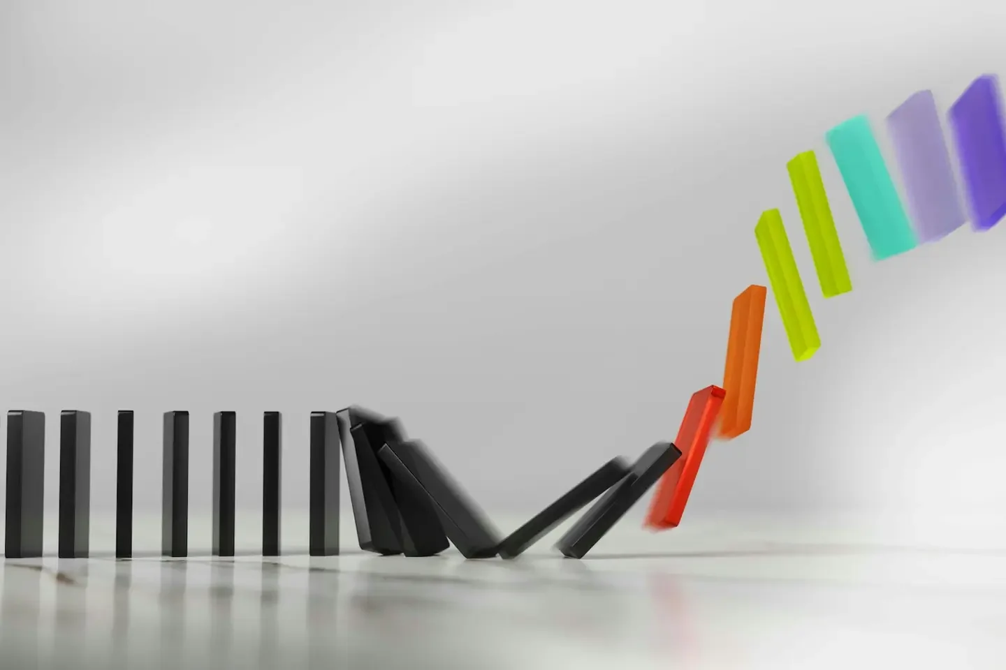 Colorful dominoes falling in a chain reaction