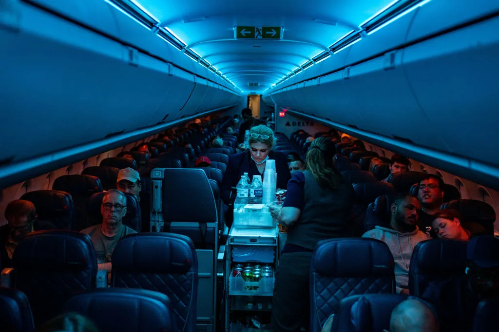 Flight attendants serve refreshments on a Delta Airlines flight 