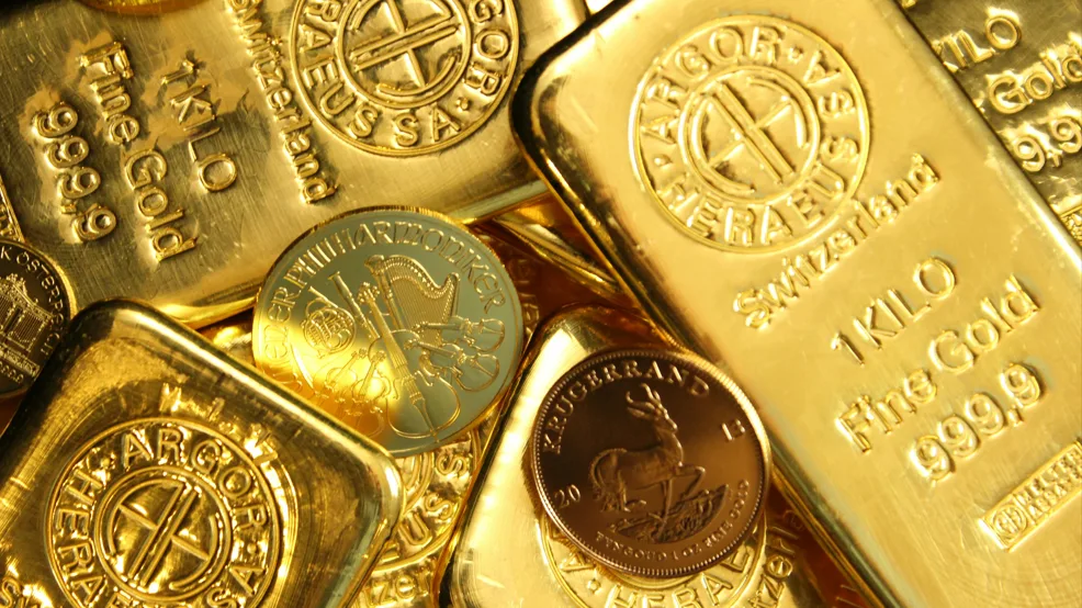 Close-up of gold coins, illustrating the surge in gold prices as investors seek stability in uncertain financial markets.