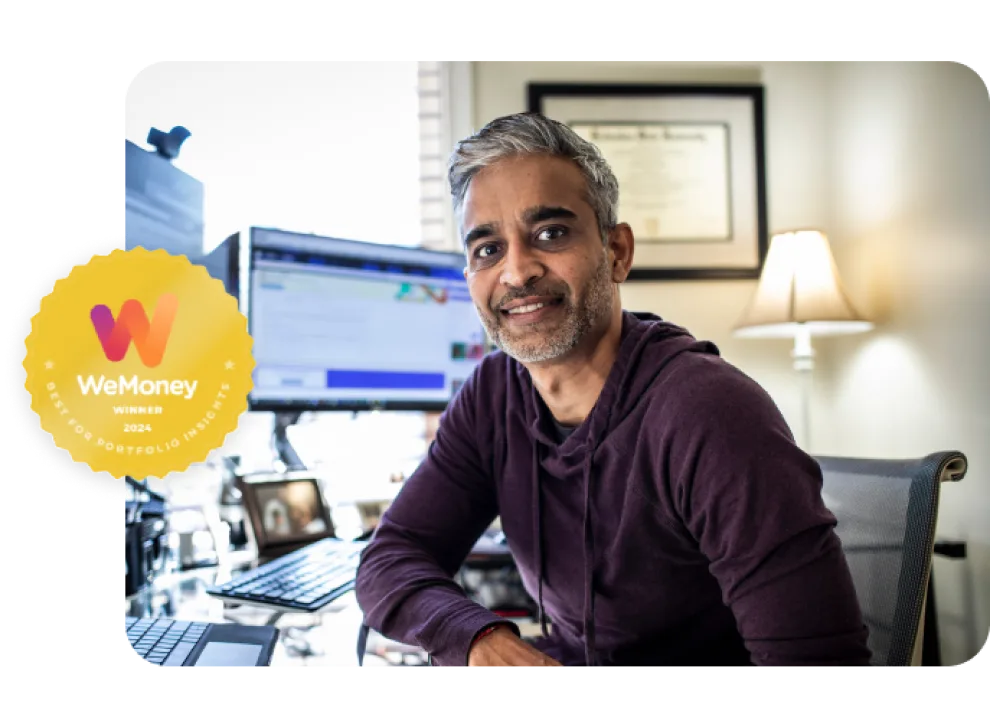 A man sits at his desktop computer. He's facing the camera and smiling, an image overlay shows an award for 'Best portfolio insights 2024' from WeMoney