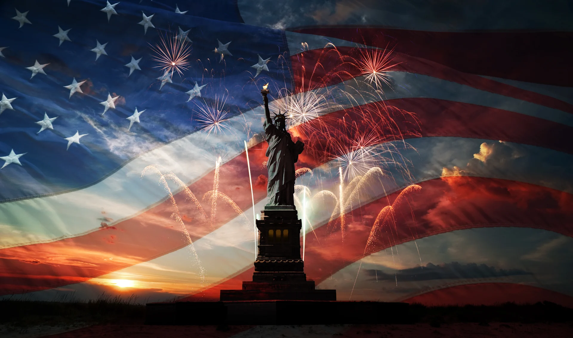 Statue of Liberty with fireworks and an American flag in the backdrop