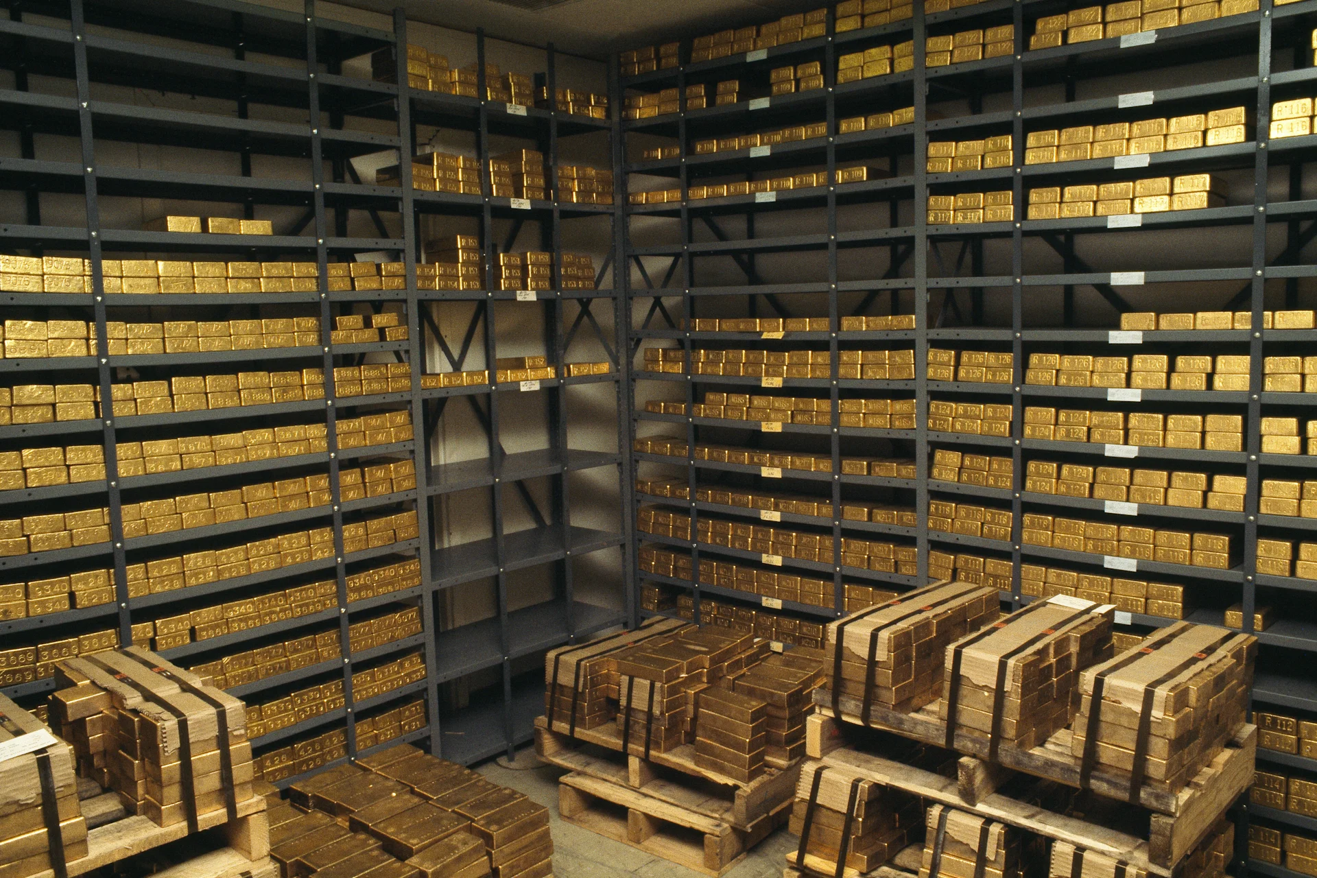 An interior space showcasing numerous shelves brimming with shiny gold bars, emphasizing wealth and abundance.