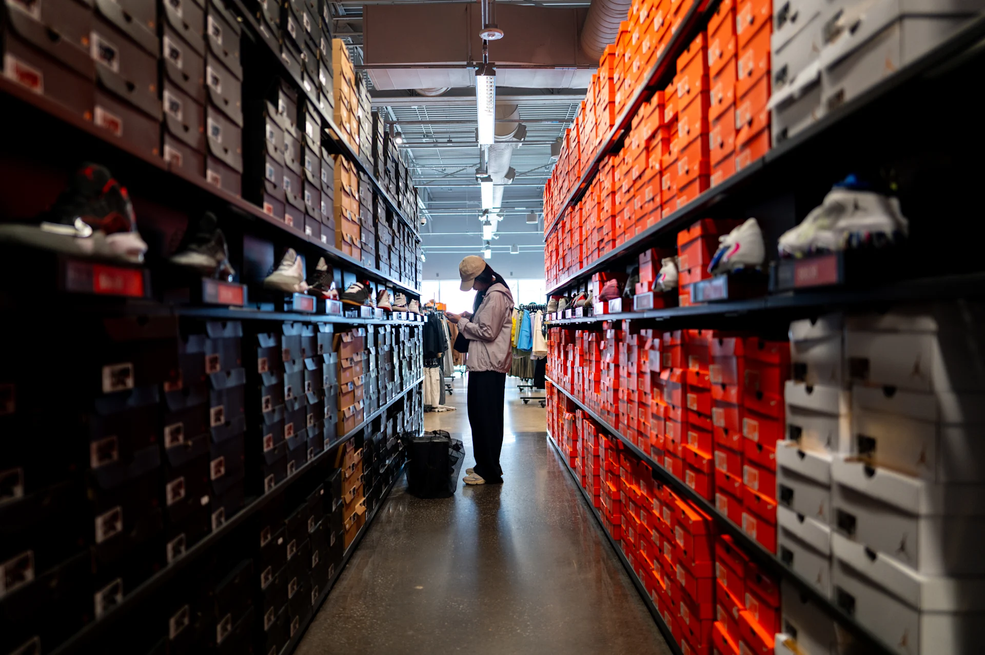 A person shops for Nike shoes at the Nike Factory store