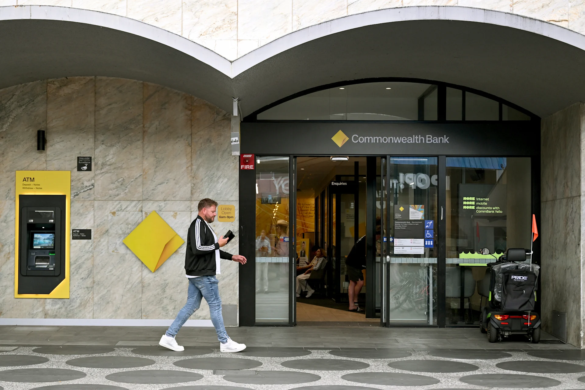 Man walks past Commonwealth Bank