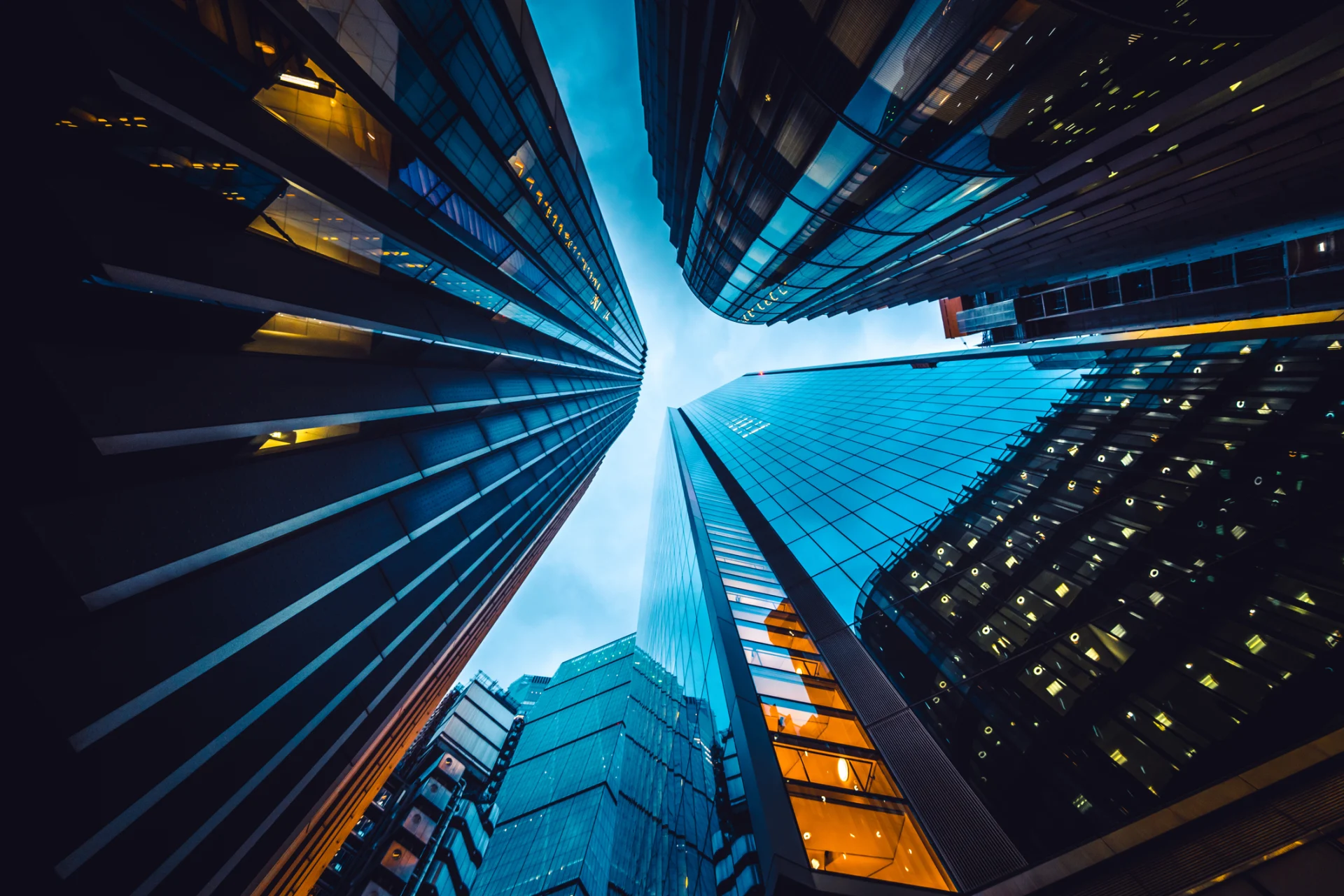 A perspective looking up at skyscrapers, highlighting their impressive height against a backdrop of the sky.