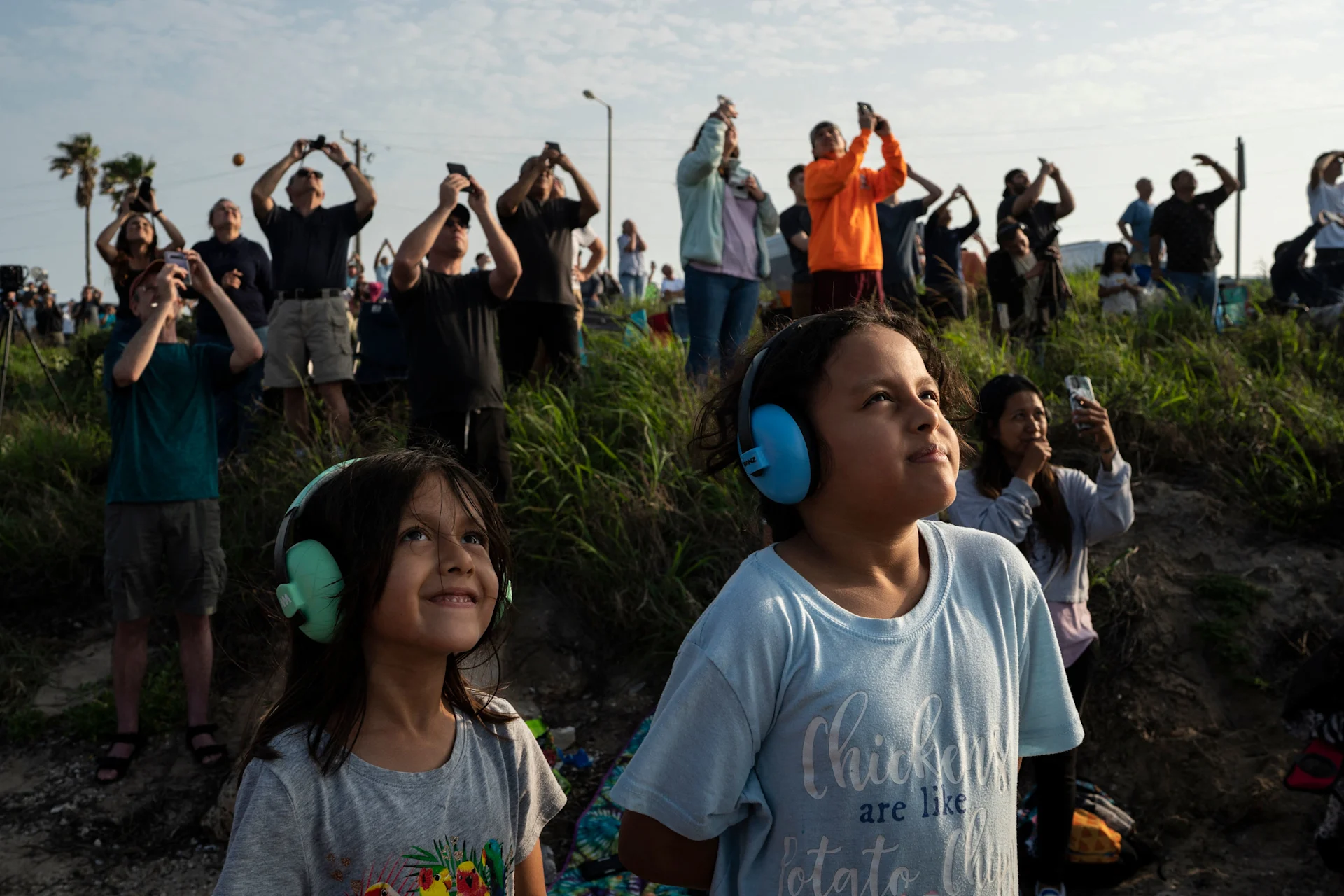 Crowd looks up at SpaceX rocket taking off