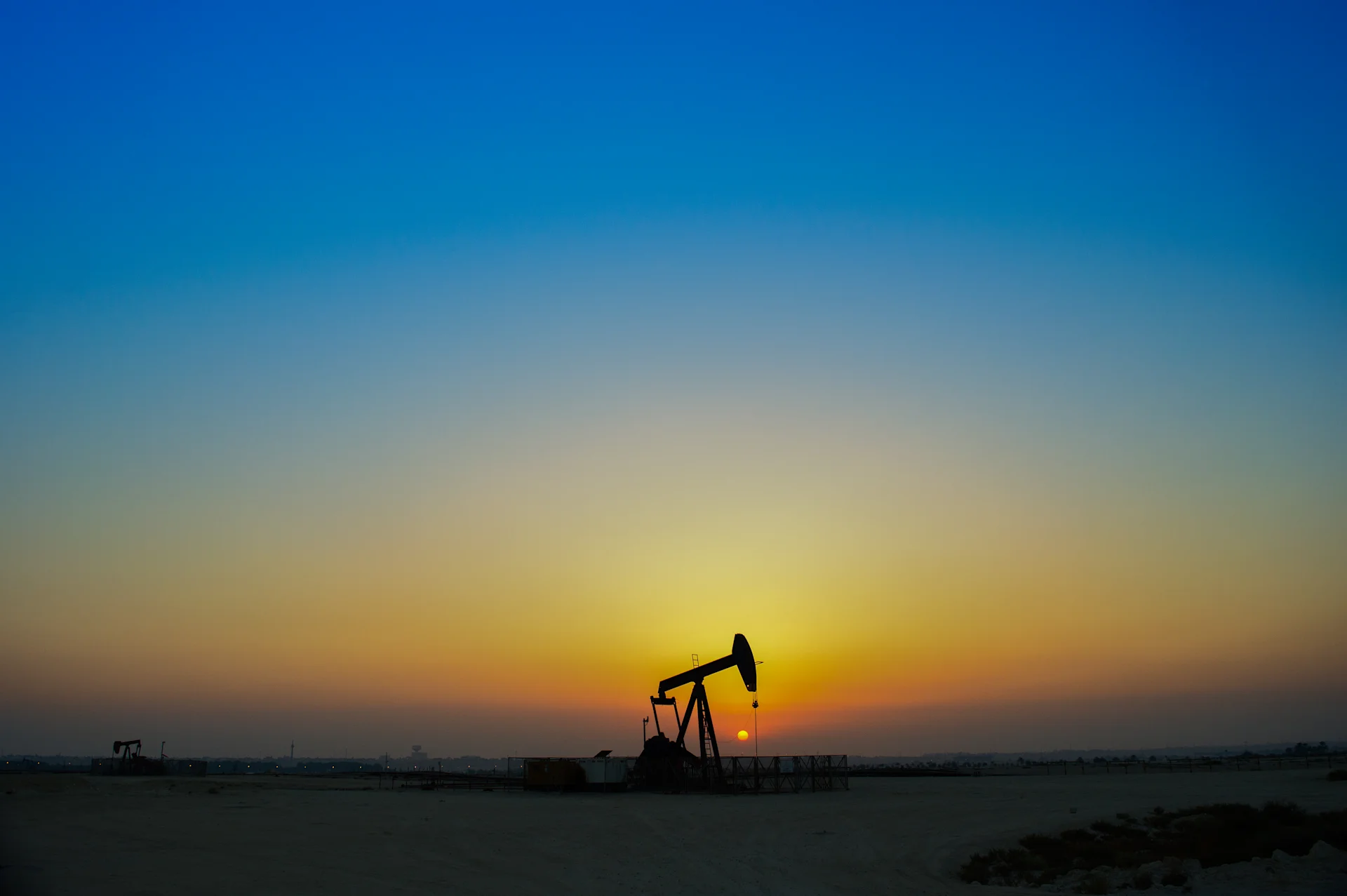 Oil well in sunrise